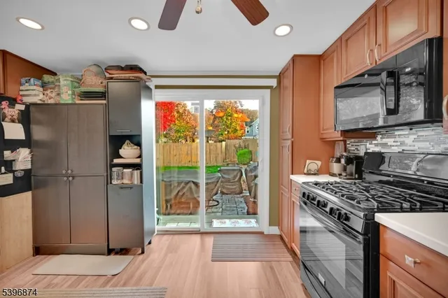 a kitchen with stainless steel appliances granite countertop a refrigerator stove and sink