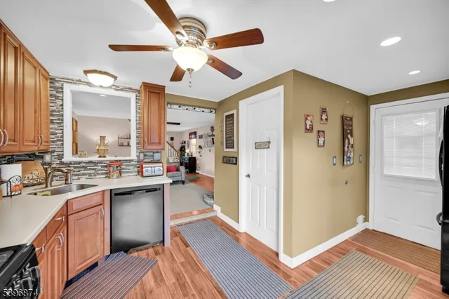 a view of a kitchen cabinets a sink and wooden floor
