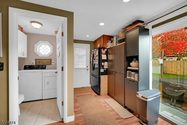 a open kitchen with white cabinets and stainless steel appliances