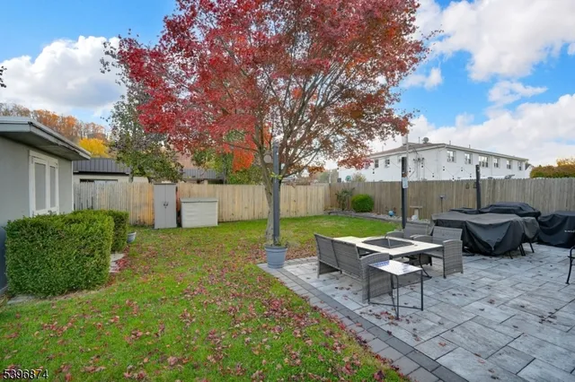 a backyard of a house with table and chairs