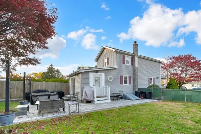 a view of a patio with table and chairs and floor to ceiling window