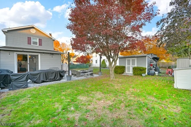 a view of a house with a yard and sitting area