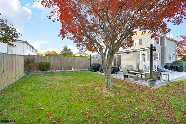 a view of a backyard with a garden and trees