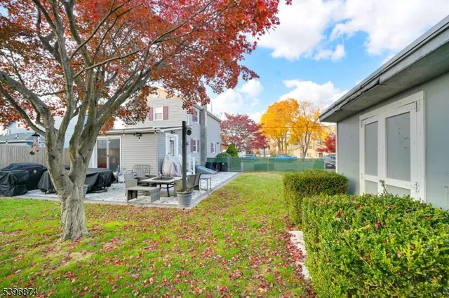 a view of a house with backyard and sitting area