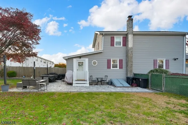 a view of a house with a yard patio and fire pit