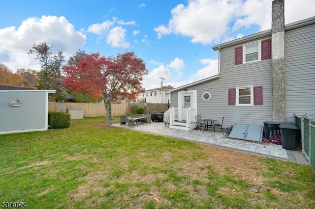 a view of backyard of house with green space