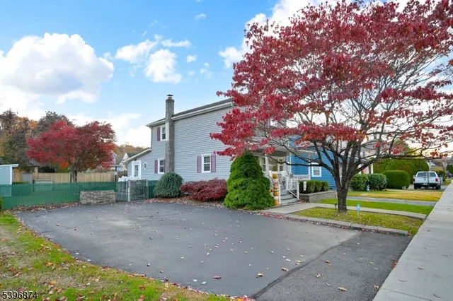 a view of a house with a big yard plants and trees
