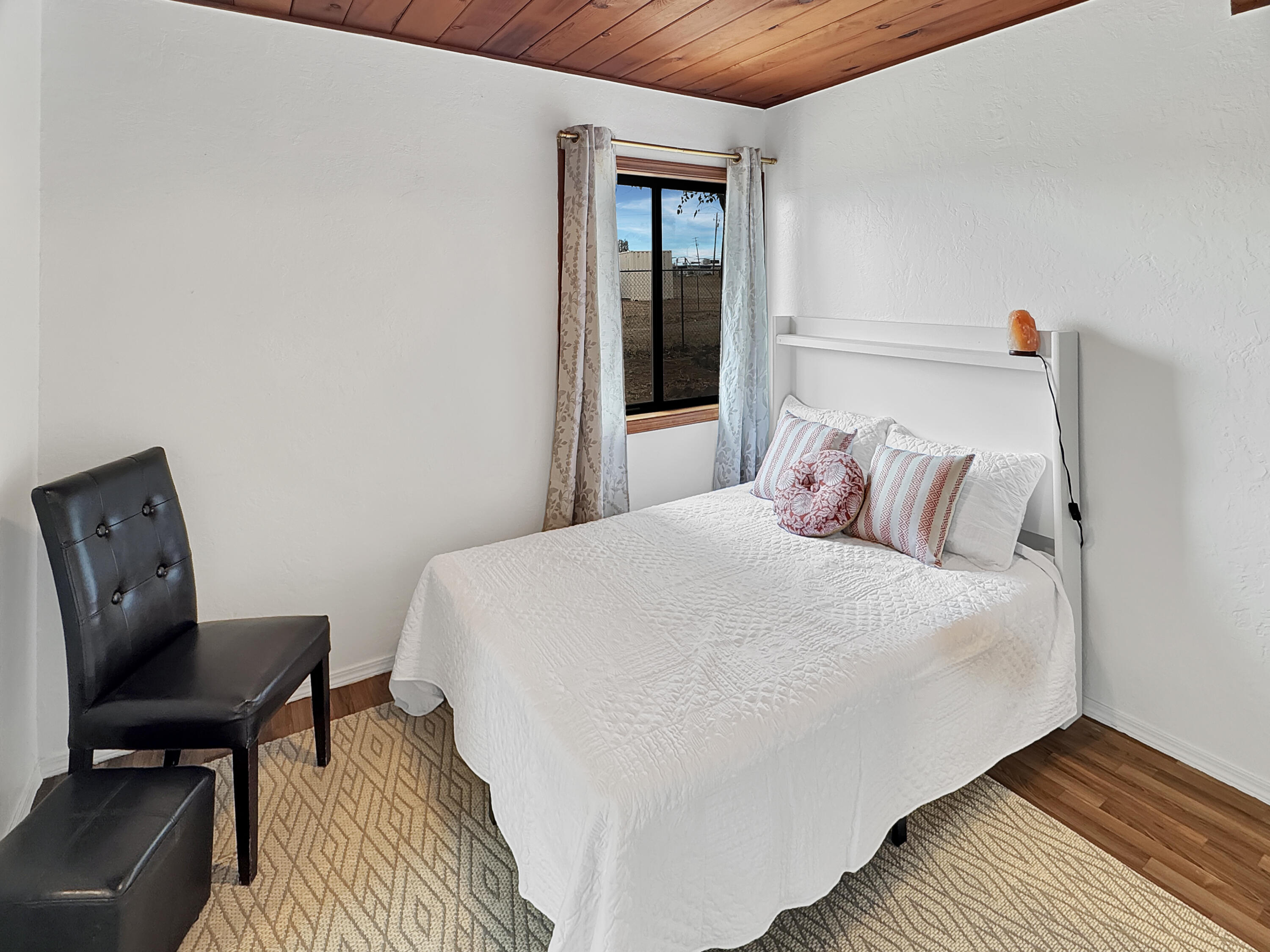 1865 Douglass Street Red Bluff, CA 96080 - Photo 11 of 24 a bedroom with a bed a chair and a window