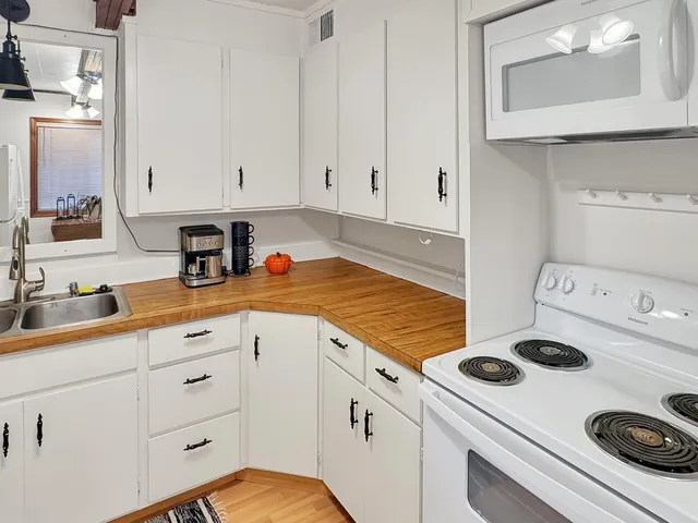 a kitchen with a stove a sink and a refrigerator