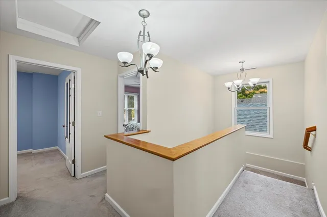 a view of a hallway with a chandelier