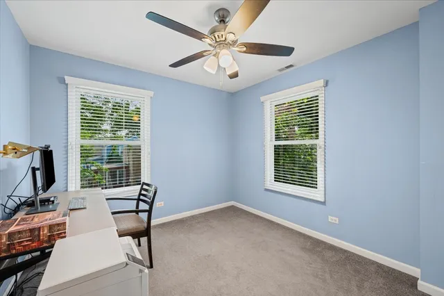 a view of a livingroom with workspace and a window