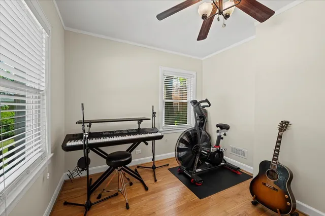 a room with gym equipment and windows
