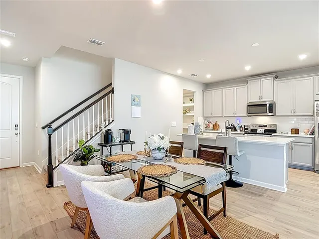a kitchen with a sink a stove and chairs