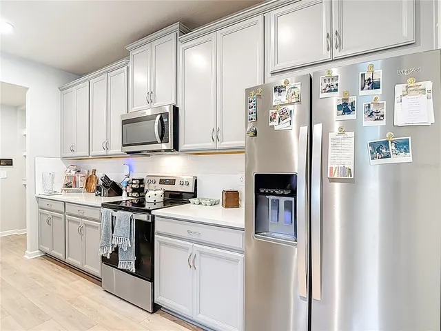 a living room with furniture kitchen view and a window