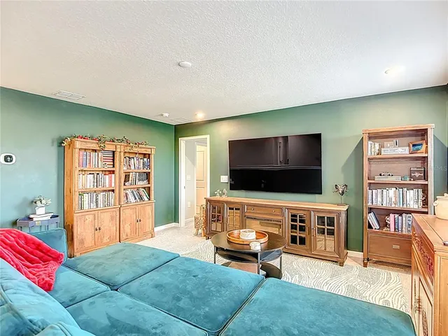 a view of walk in closet with clothes