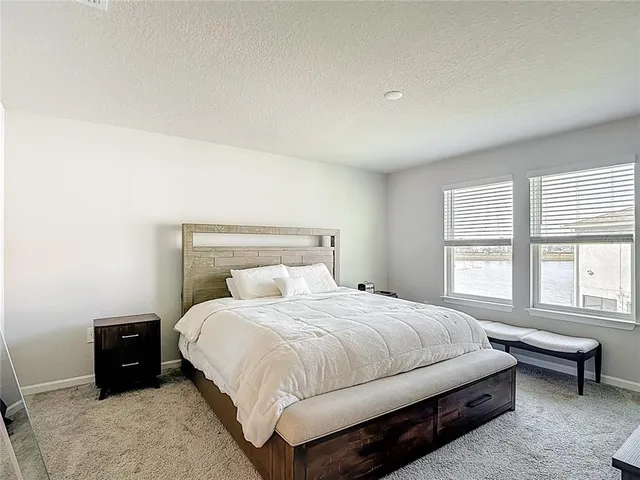a lobby with furniture and floor to ceiling window