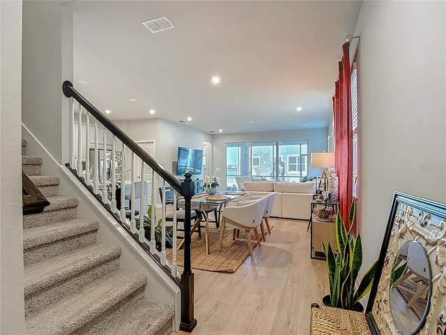 a dining room with furniture and wooden floor