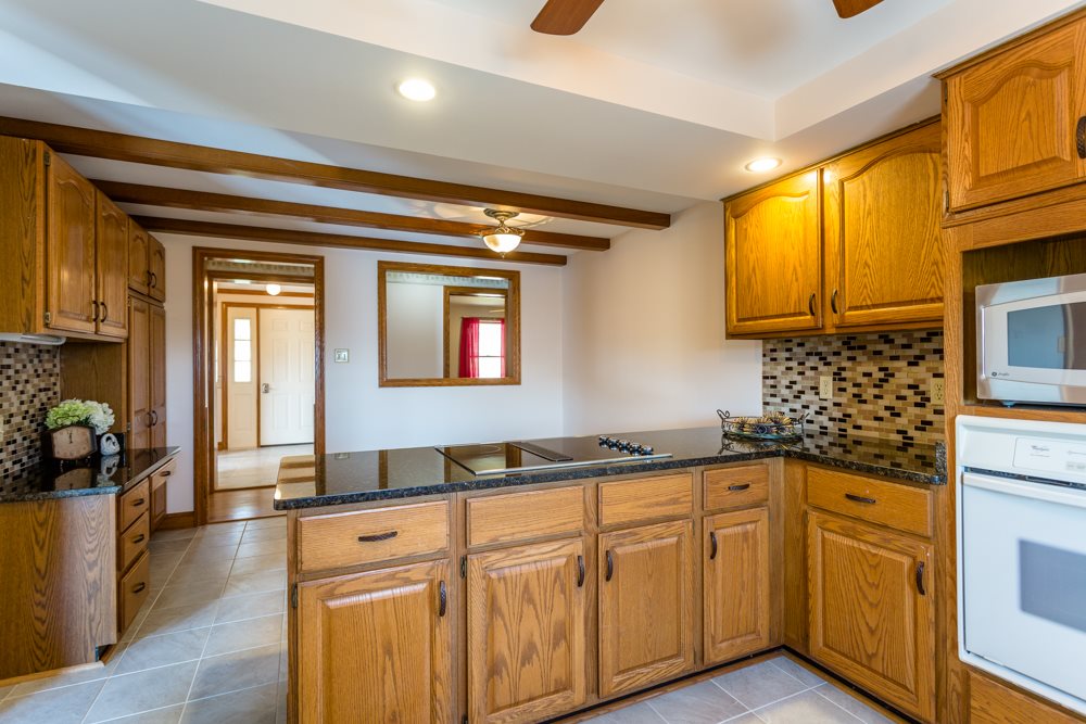 3841 Bull Run Road Penn Laird, VA 22846 - Photo 5 of 49 a kitchen with granite countertop cabinets a sink a window and stainless steel appliances
