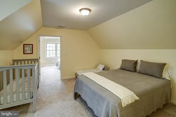 a bedroom with a bed and lamp