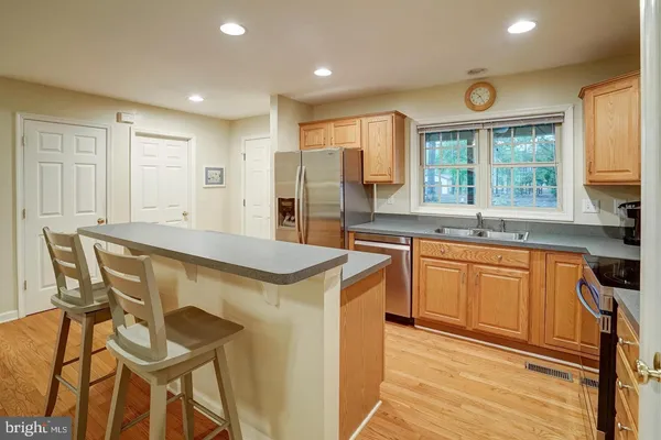 a kitchen with granite countertop a sink and cabinets