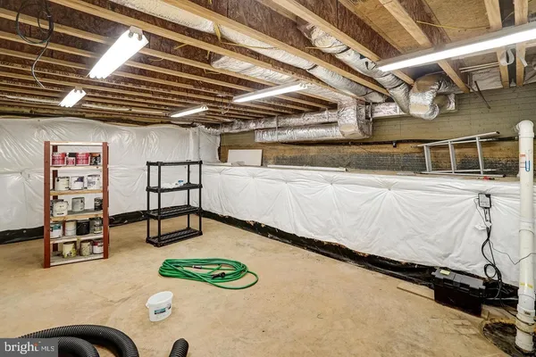 a view of walk in closet with clothes