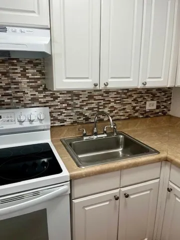 a kitchen with a sink and cabinets