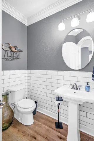 a kitchen with stainless steel appliances granite countertop a stove a sink a refrigerator dining table and chairs