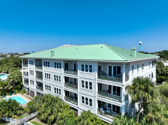 an aerial view of a house with swimming pool and outdoor seating
