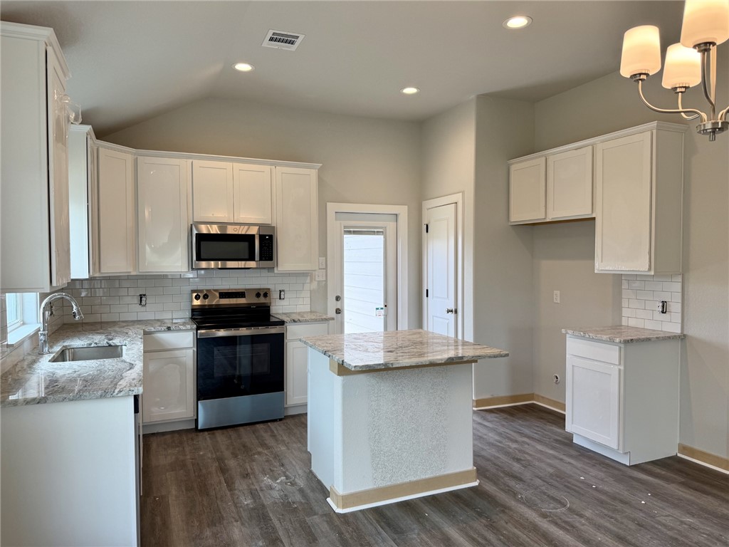 2791 Messenger Way Bryan, TX 77803 - Photo 3 of 15 a kitchen with stainless steel appliances granite countertop a stove a sink and a refrigerator