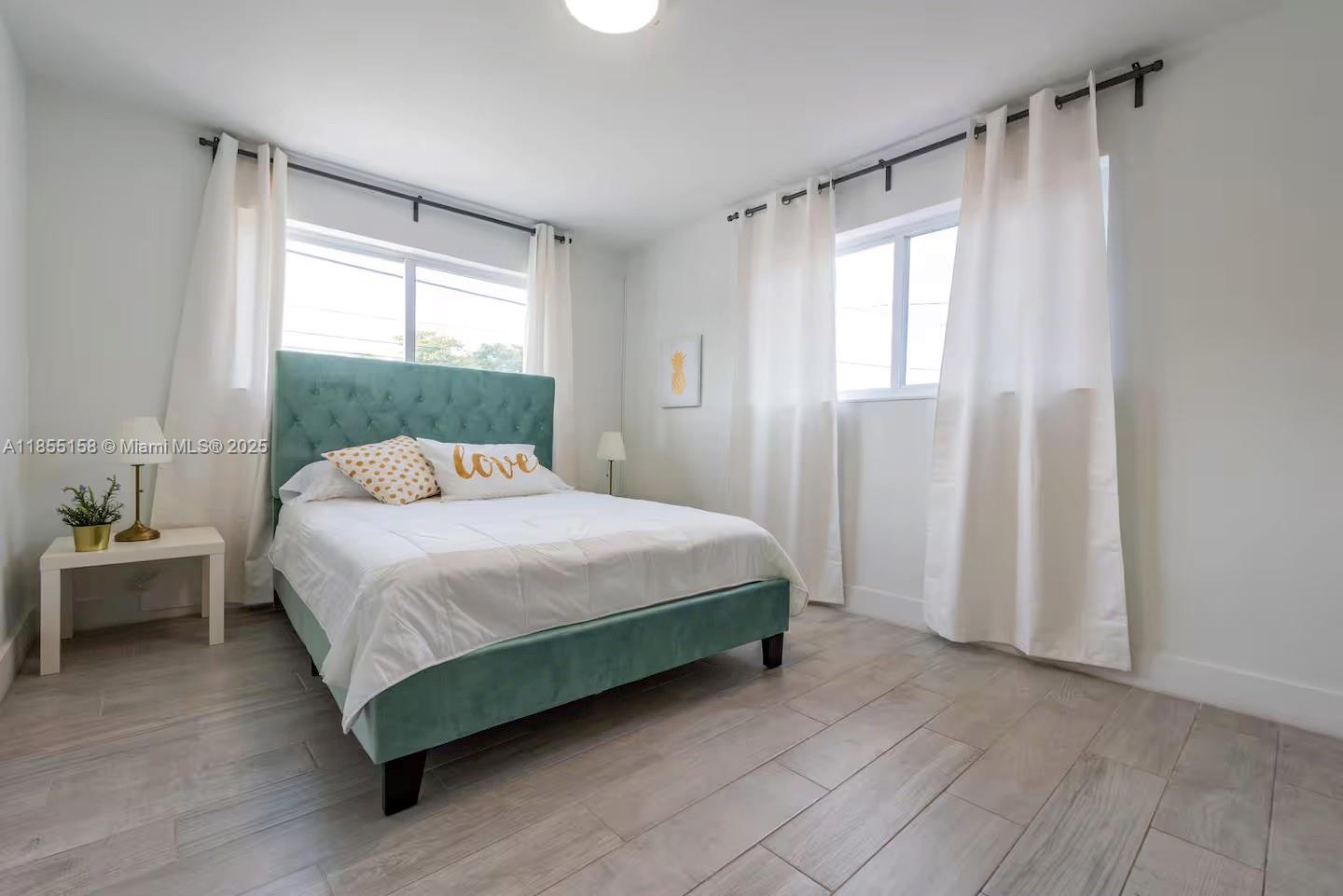 350 Northwest 50th Street Miami, FL 33127 - Photo 12 of 27 a bedroom with a bed and a window