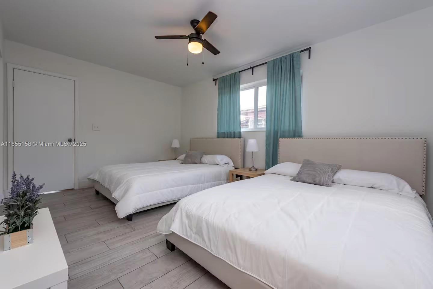 350 Northwest 50th Street Miami, FL 33127 - Photo 13 of 27 a bedroom with two beds and a potted plant