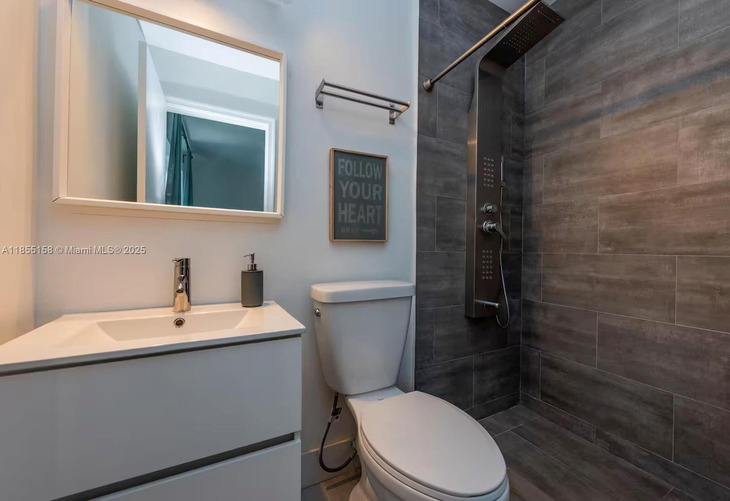 350 Northwest 50th Street Miami, FL 33127 - Photo 14 of 27 a white toilet sitting next to a bathroom sink