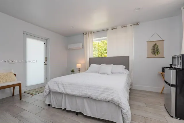 a bedroom with a bed and a flat screen tv