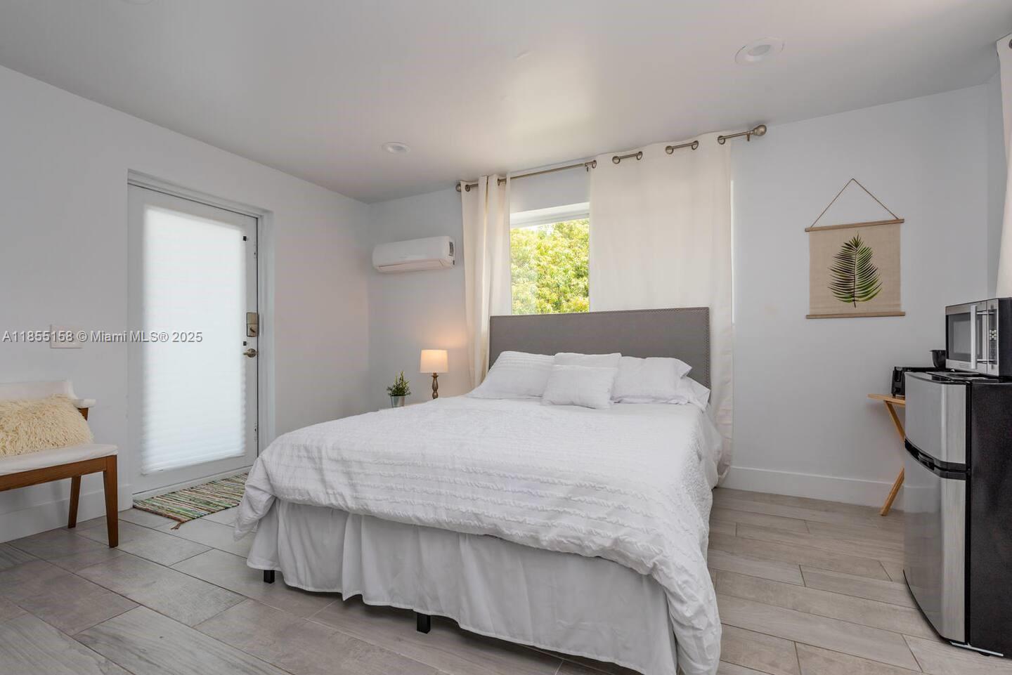 350 Northwest 50th Street Miami, FL 33127 - Photo 23 of 27 a bedroom with a bed and a table in it