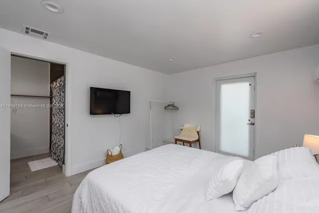 a bedroom with bed and window