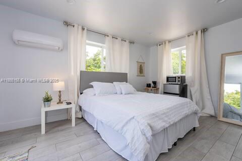 350 Northwest 50th Street Miami, FL 33127 - Photo 25 of 27 a bedroom with bed and window