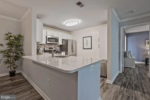 a kitchen with sink stove and refrigerator