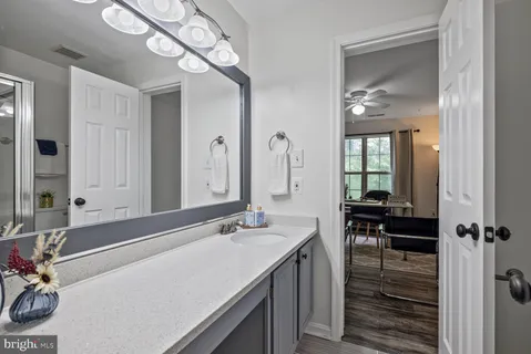 a living room with furniture and a view of kitchen chandelier
