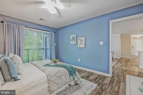 a bedroom with a large bed and a window