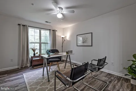 a living room with furniture a fireplace and a large window