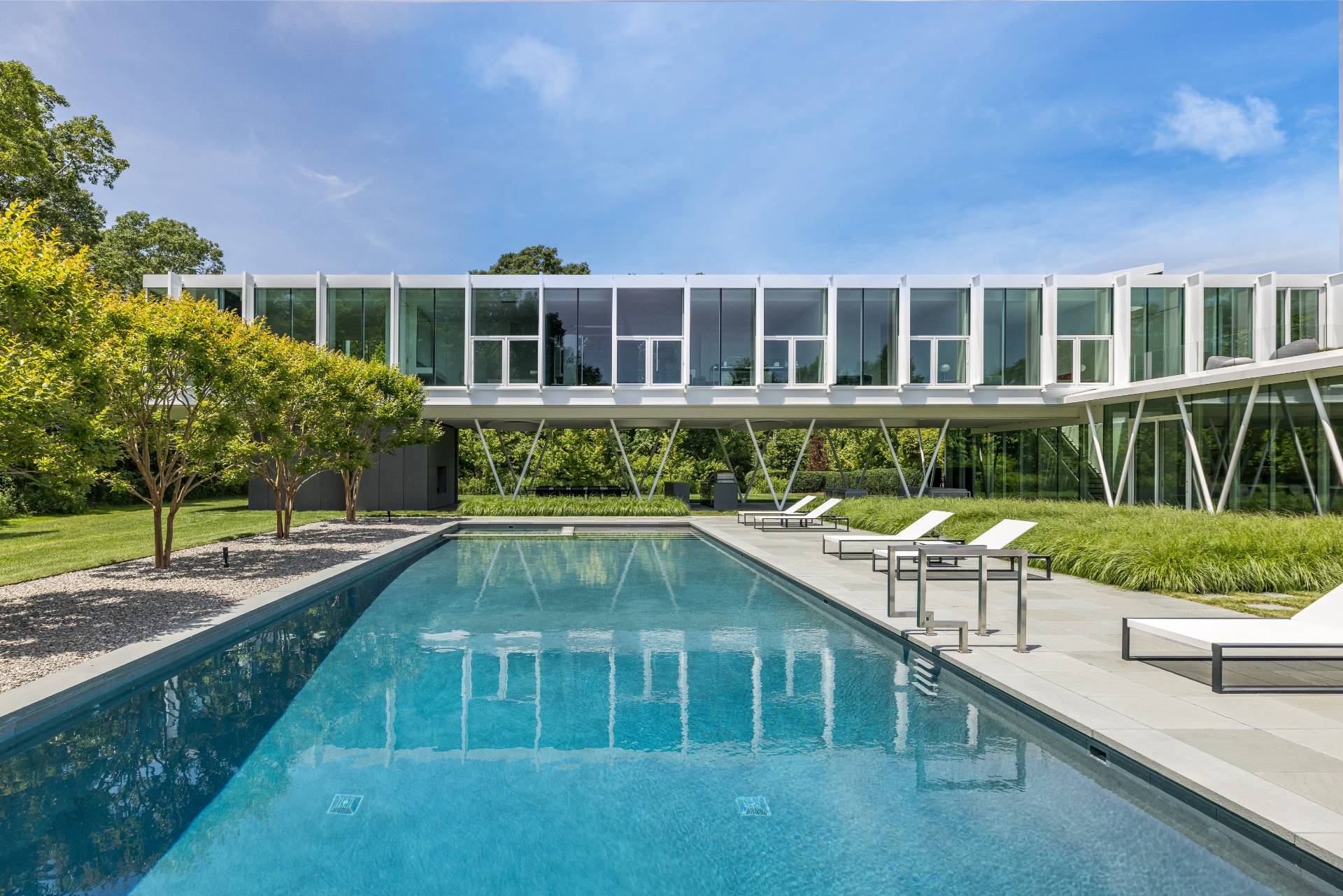 13 Terry's Trail East Hampton, NY 11937 - Photo 12 of 46 a front view of a house with a yard table and chairs