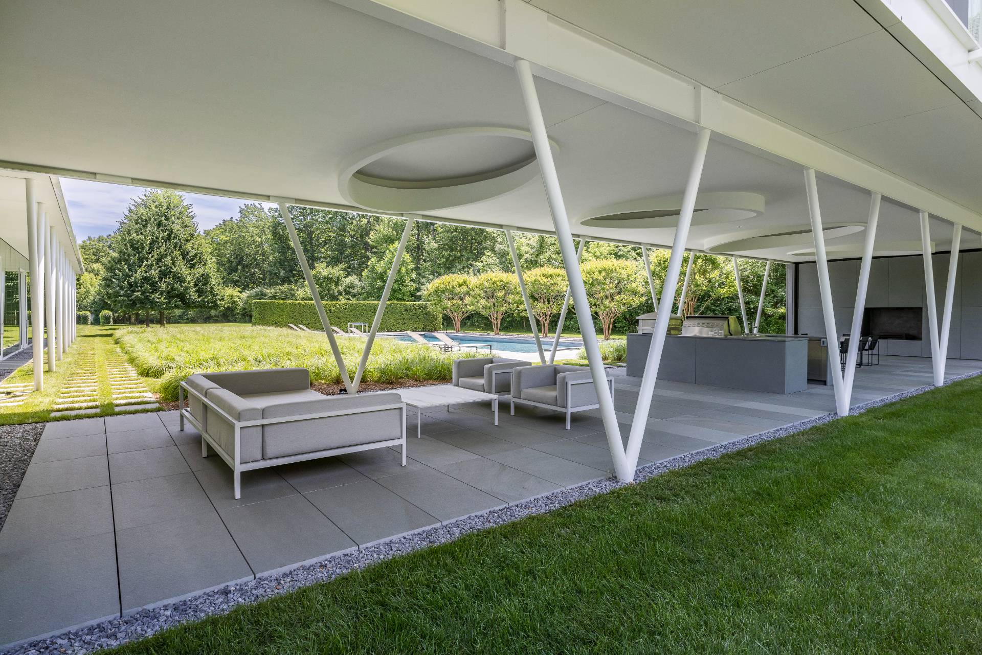 13 Terry's Trail East Hampton, NY 11937 - Photo 14 of 46 a view of a chair and table in the garden
