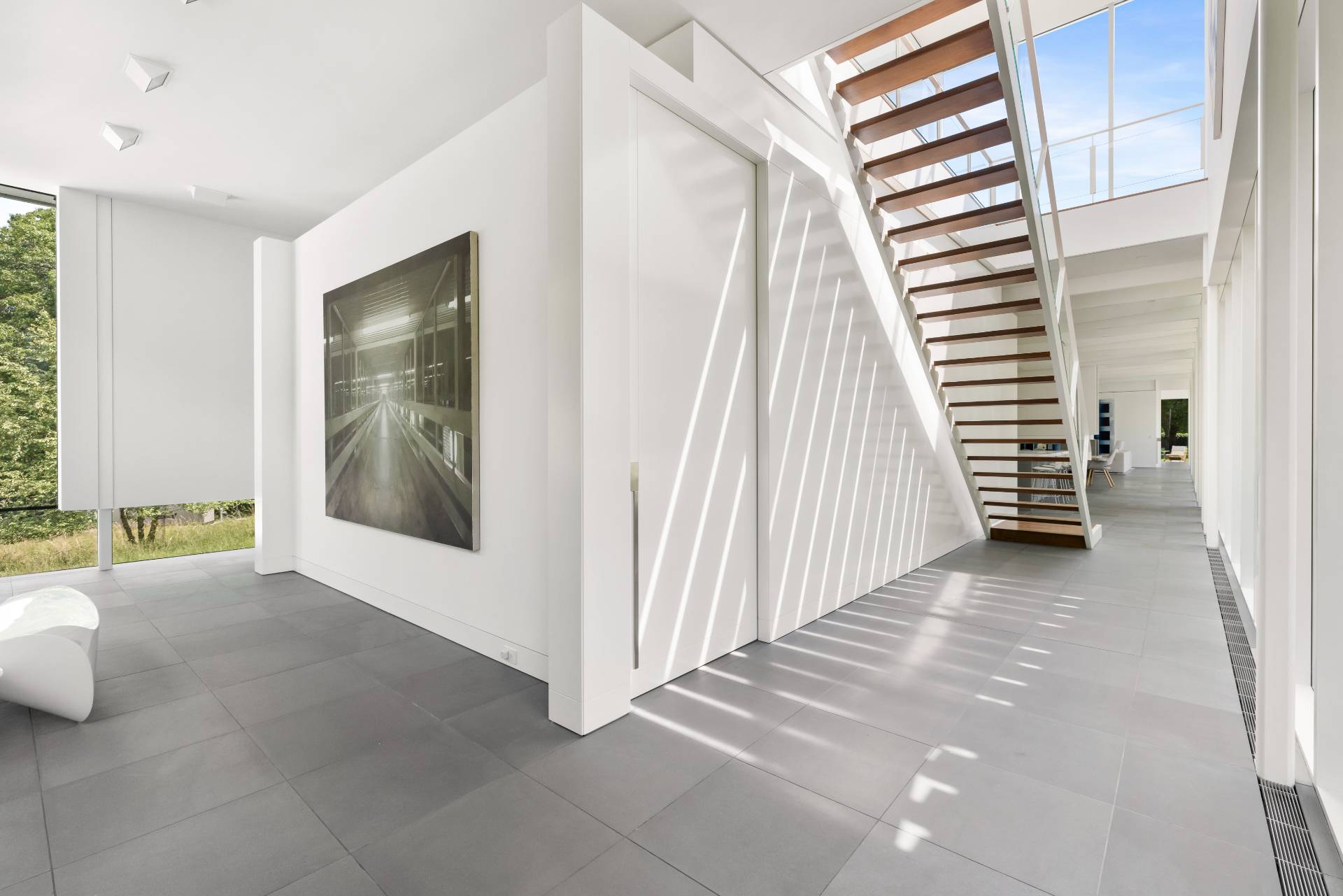 13 Terry's Trail East Hampton, NY 11937 - Photo 20 of 46 a view of a room with a large window and stairs