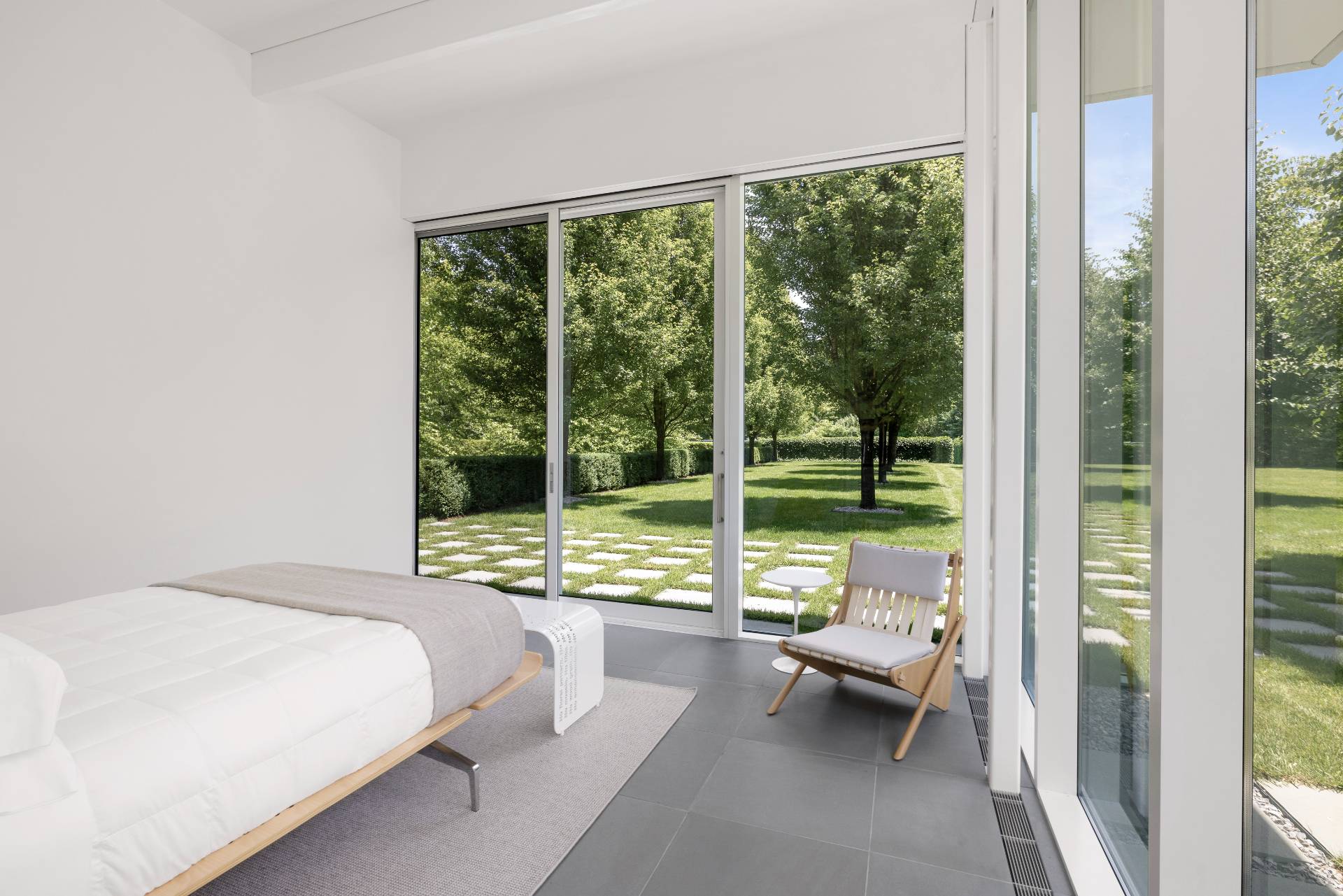 13 Terry's Trail East Hampton, NY 11937 - Photo 27 of 46 a bedroom with a bed and large windows