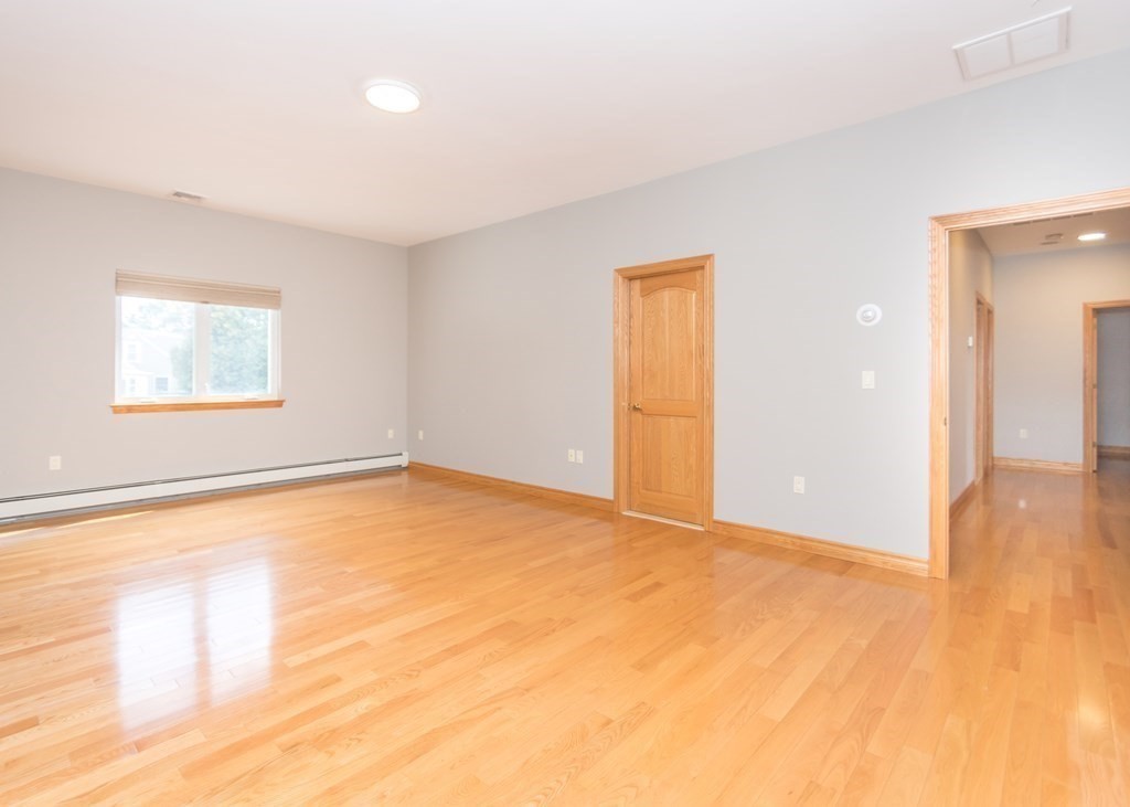 129 Beal Road Waltham, MA 02453 - Photo 18 of 31 a view of an empty room with wooden floor and a window