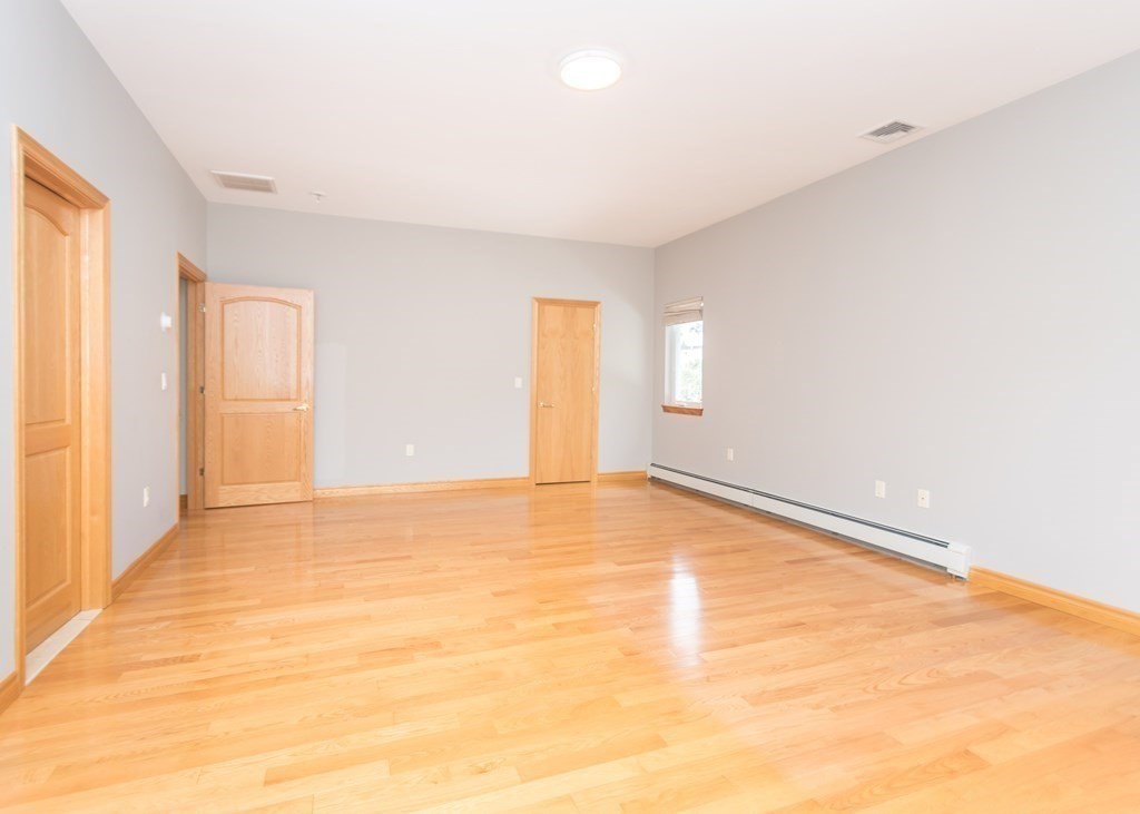 129 Beal Road Waltham, MA 02453 - Photo 19 of 31 a view of an empty room with wooden floor and a window