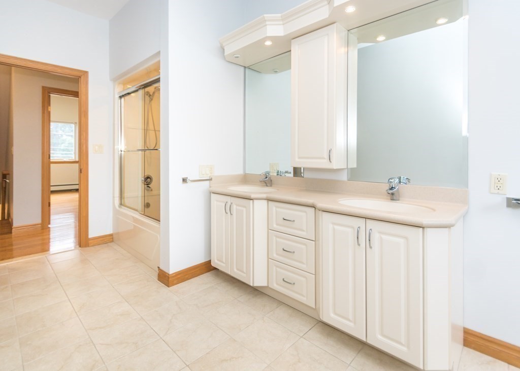 129 Beal Road Waltham, MA 02453 - Photo 22 of 31 a spacious bathroom with a granite countertop sink and a mirror