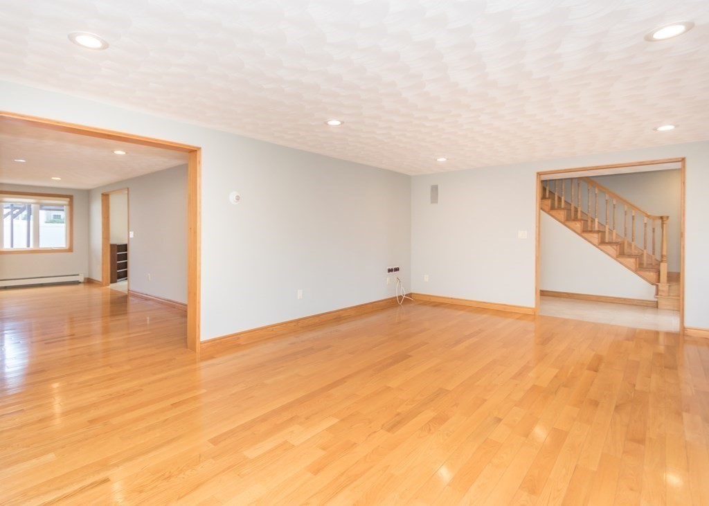 129 Beal Road Waltham, MA 02453 - Photo 4 of 31 an empty room with wooden floor and windows