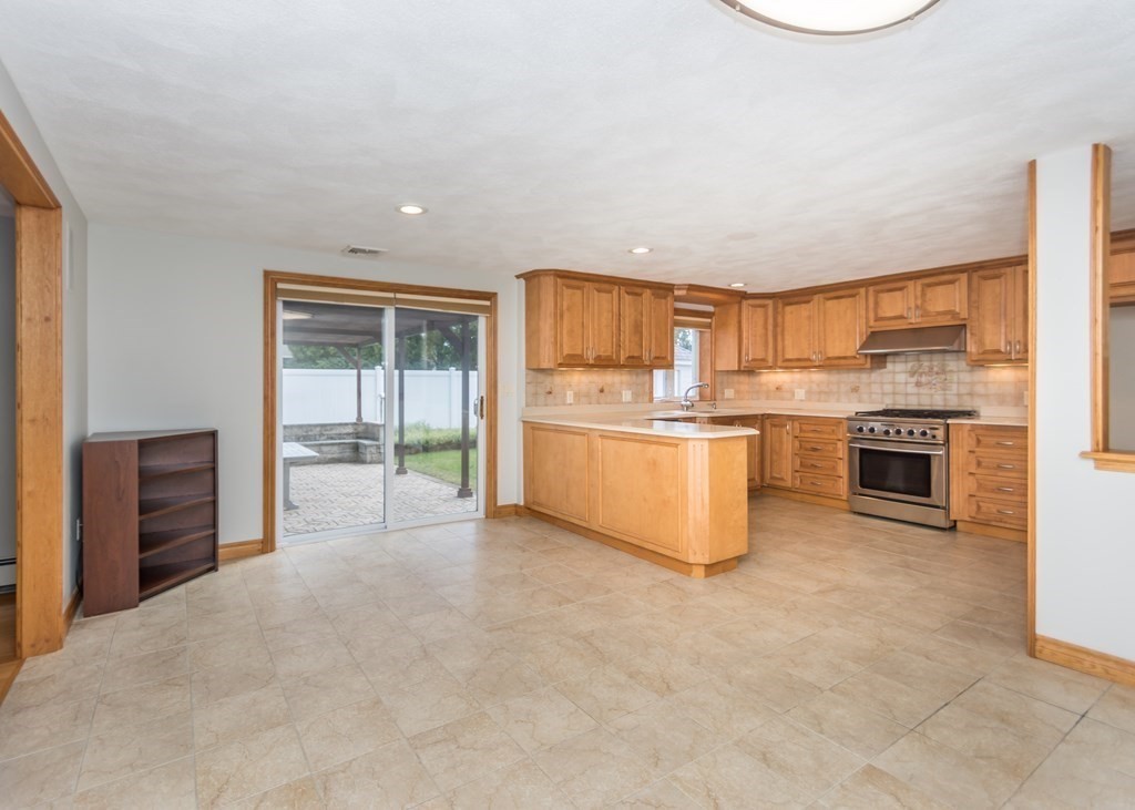 129 Beal Road Waltham, MA 02453 - Photo 7 of 31 a kitchen with stainless steel appliances granite countertop a stove top oven and a refrigerator