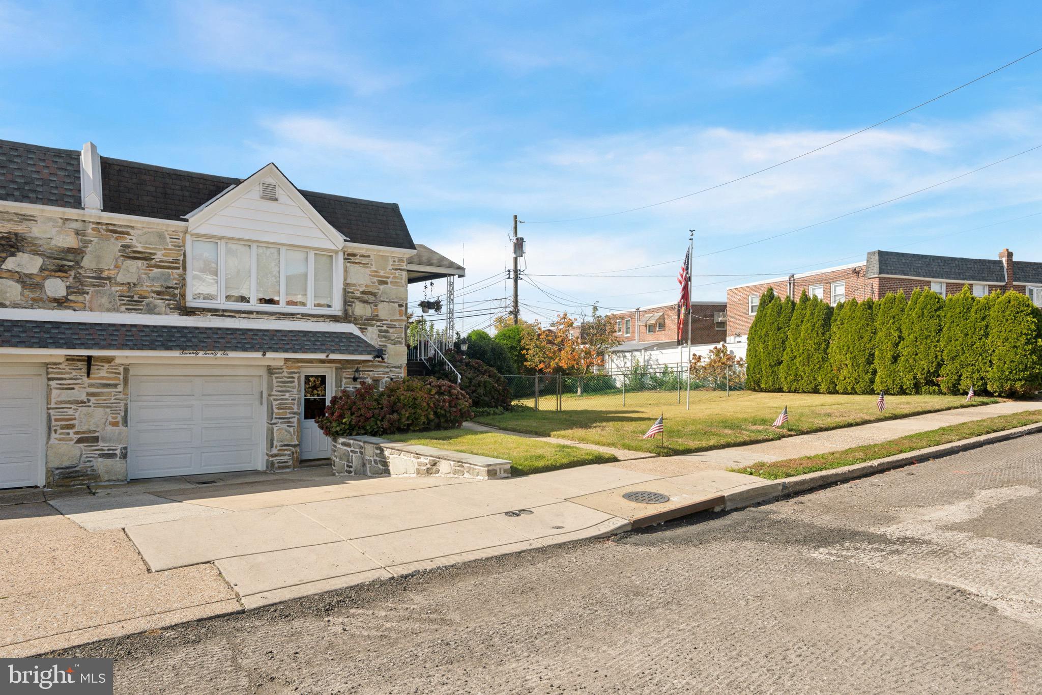 7026 Crease Lane Philadelphia, PA 19128 - Photo 1 of 41 a view of a house with a small yard and large trees